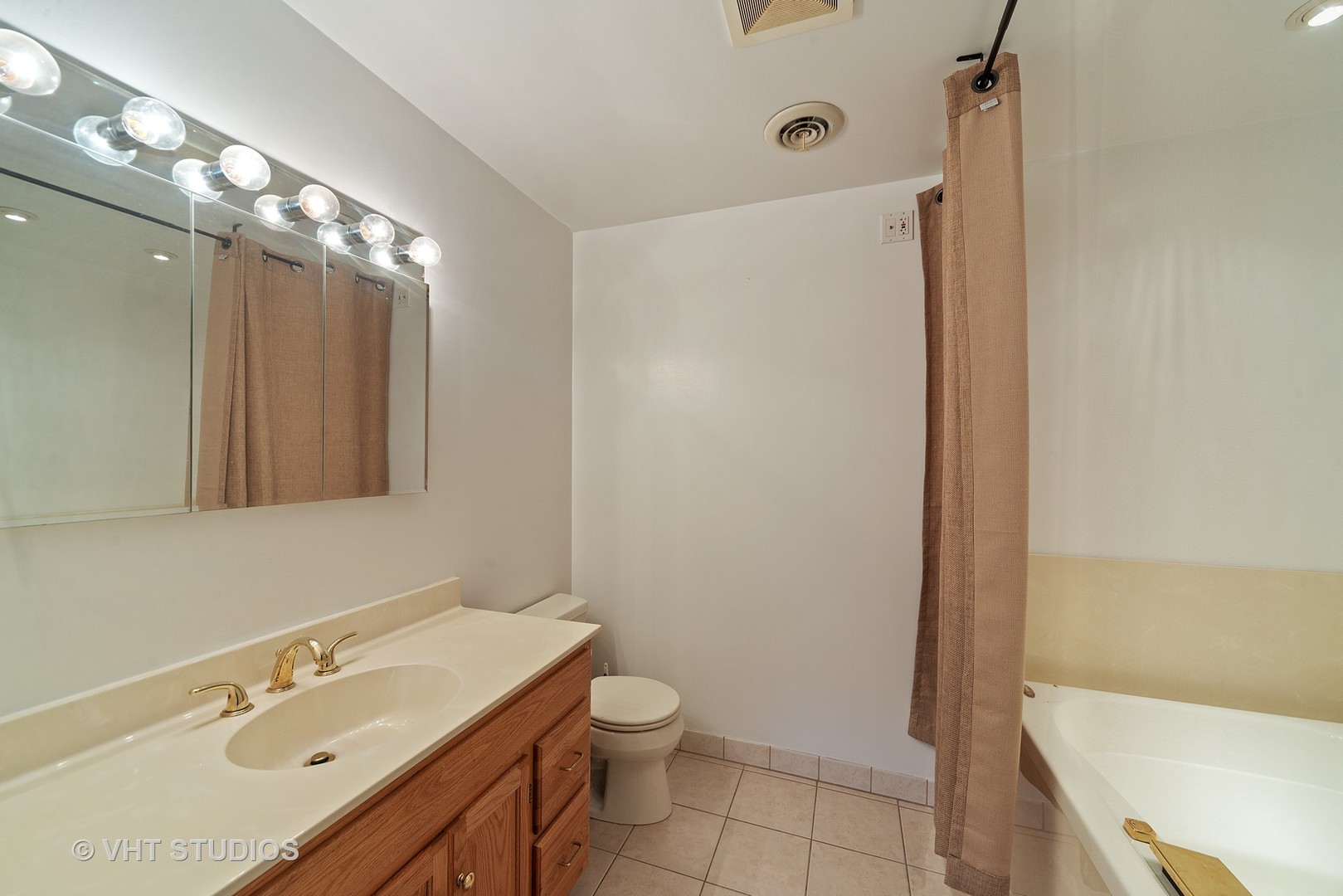 197 West Butterfield Road Elmhurst, IL 60126 - Photo 12 of 15 a bathroom with a sink a toilet and shower