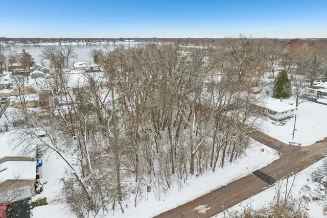 a view of wooden floor with a tree in the background