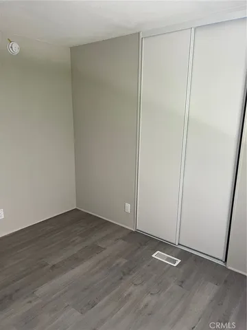 an empty room with wooden floor