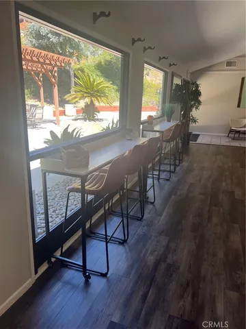 a view of a room with furniture and wooden floor