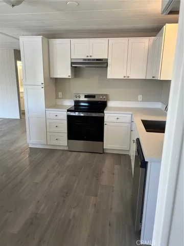 a kitchen with cabinets appliances and a window