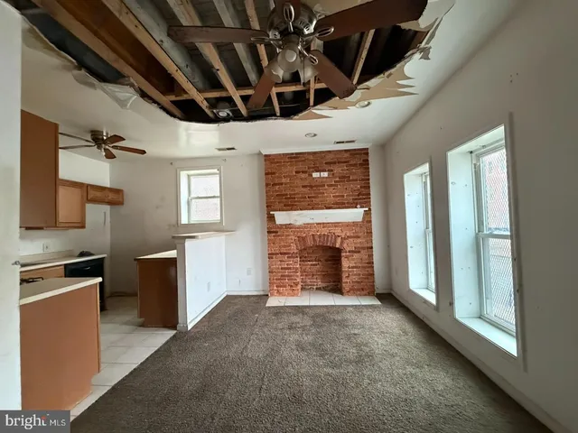 wooden floor in an empty room with a fireplace
