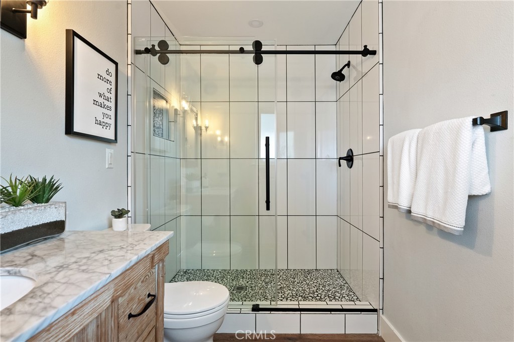 190 Verdon Street Morro Bay, CA 93442 - Photo 19 of 27 a bathroom with a granite countertop sink a toilet and shower