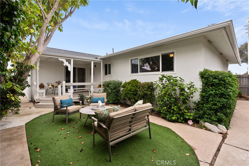 190 Verdon Street Morro Bay, CA 93442 - Photo 23 of 27 a view of a patio with table and chairs potted plants and a large tree