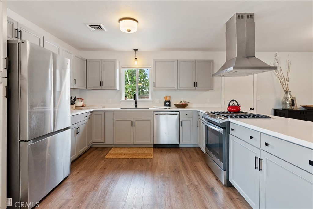 190 Verdon Street Morro Bay, CA 93442 - Photo 7 of 27 a kitchen with white cabinets sink and white appliances