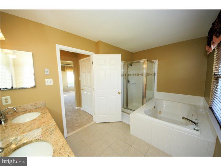 71 Amberfield Road Robbinsville, NJ 08691 - Photo 17 of 25 a bathroom with a tub sink and mirror