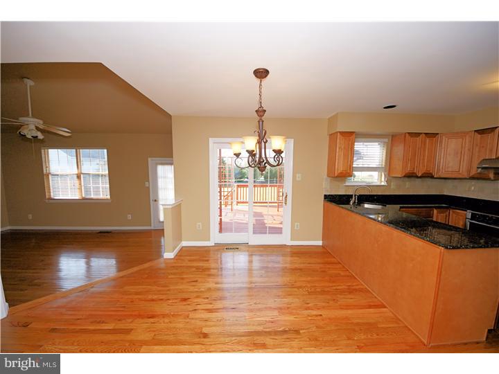 71 Amberfield Road Robbinsville, NJ 08691 - Photo 9 of 25 a large kitchen with granite countertop a stove a sink and a wooden floors