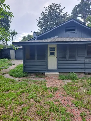 a view of house with backyard