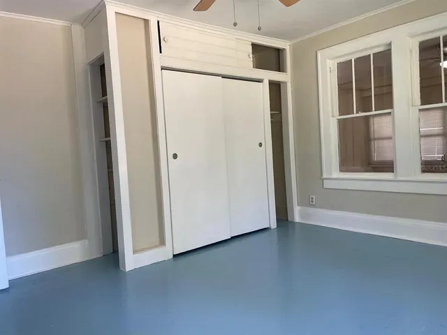 a view of a room with wooden floor and windows