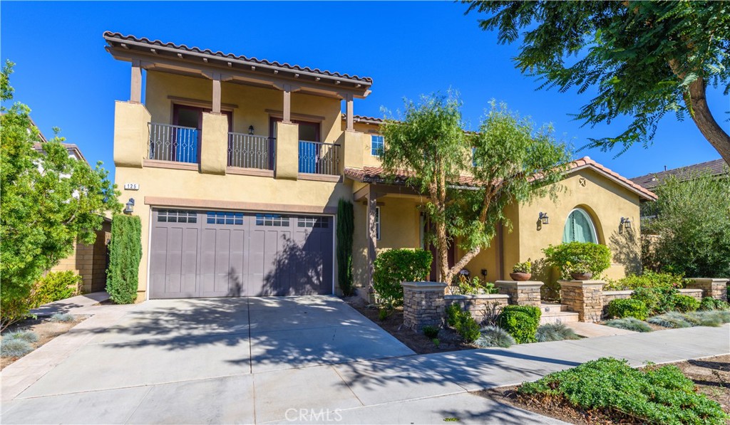 125 Paramount Irvine, CA 92618 - Photo 1 of 1 a front view of a house with a yard and garage
