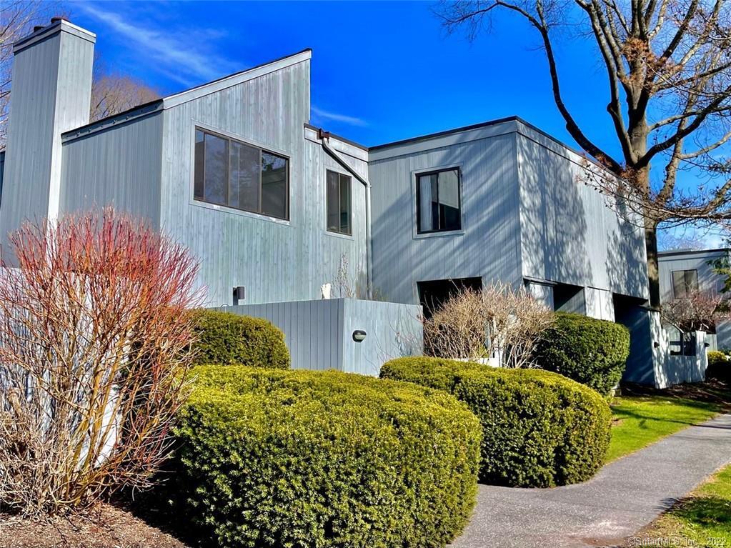 7 Juneberry Lane, Unit 7 Ridgefield, CT 06877 - Photo 1 of 1 a front view of a house with garden
