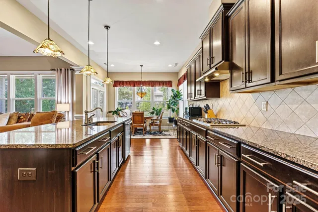a kitchen with stainless steel appliances lots of counter space and wooden floor
