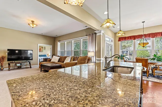 a living room with fireplace furniture and a flat screen tv
