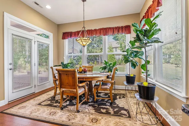 a view of a dining room with furniture window and wooden floor