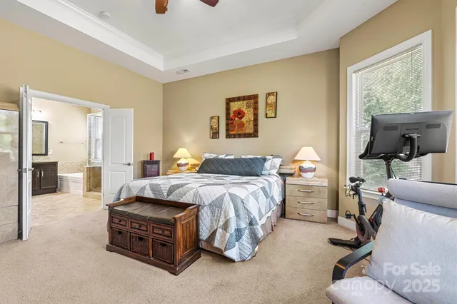 a spacious bedroom with a bed and large windows