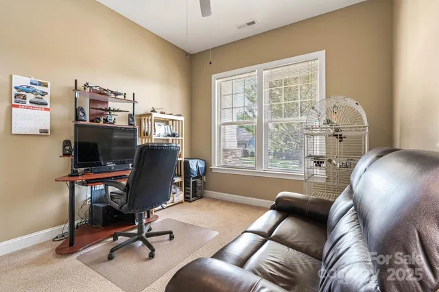 a view of a livingroom with workspace and a window