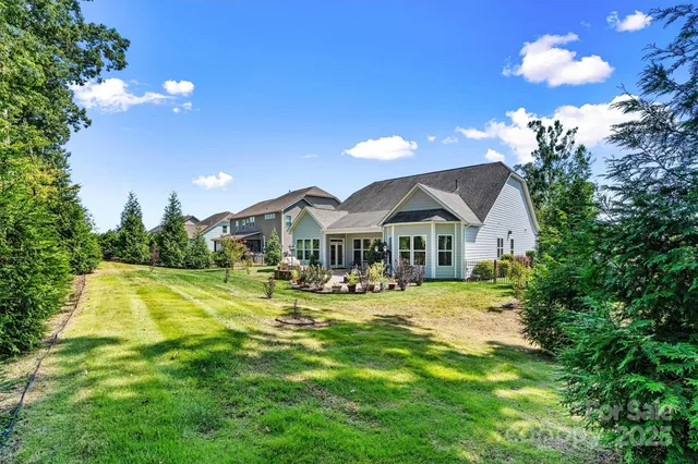 a view of a house with swimming pool and sitting area