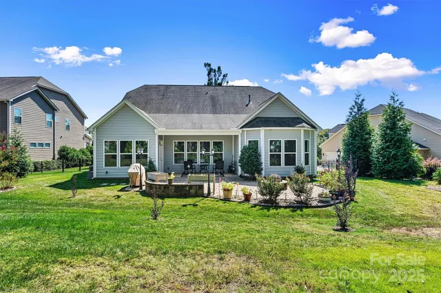 a front view of a house with garden and outdoor seating