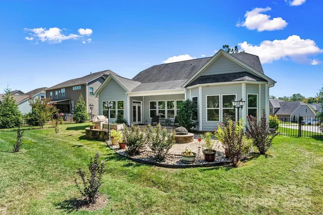a view of a house with a yard porch and furniture