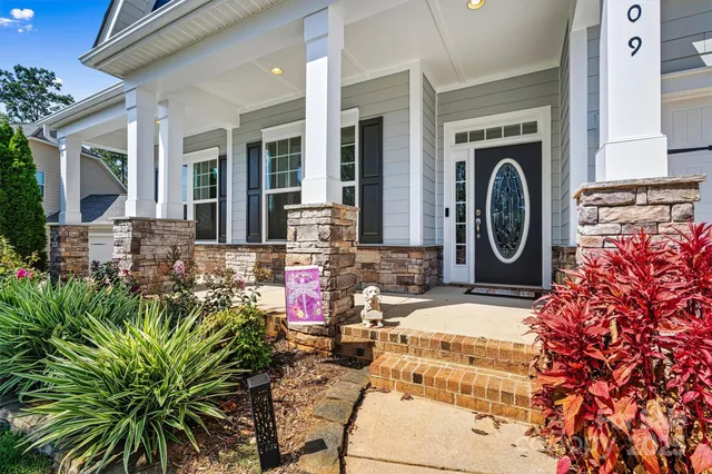 a view of a entryway of the house with outdoor seating