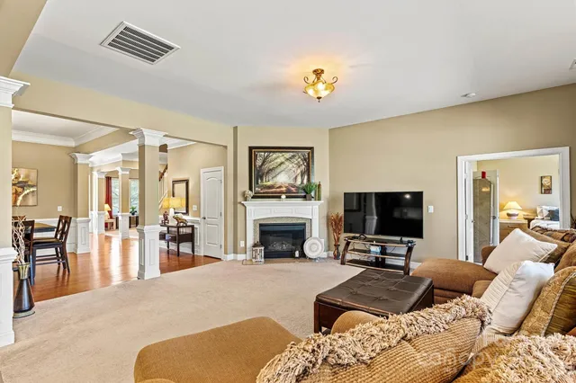 a living room with furniture a fireplace and a flat screen tv