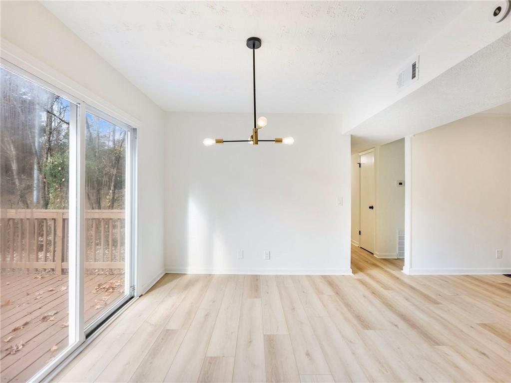 930 Woodbridge Drive Northeast Conyers, GA 30012 - Photo 12 of 38 a view of empty room with wooden floor and fan