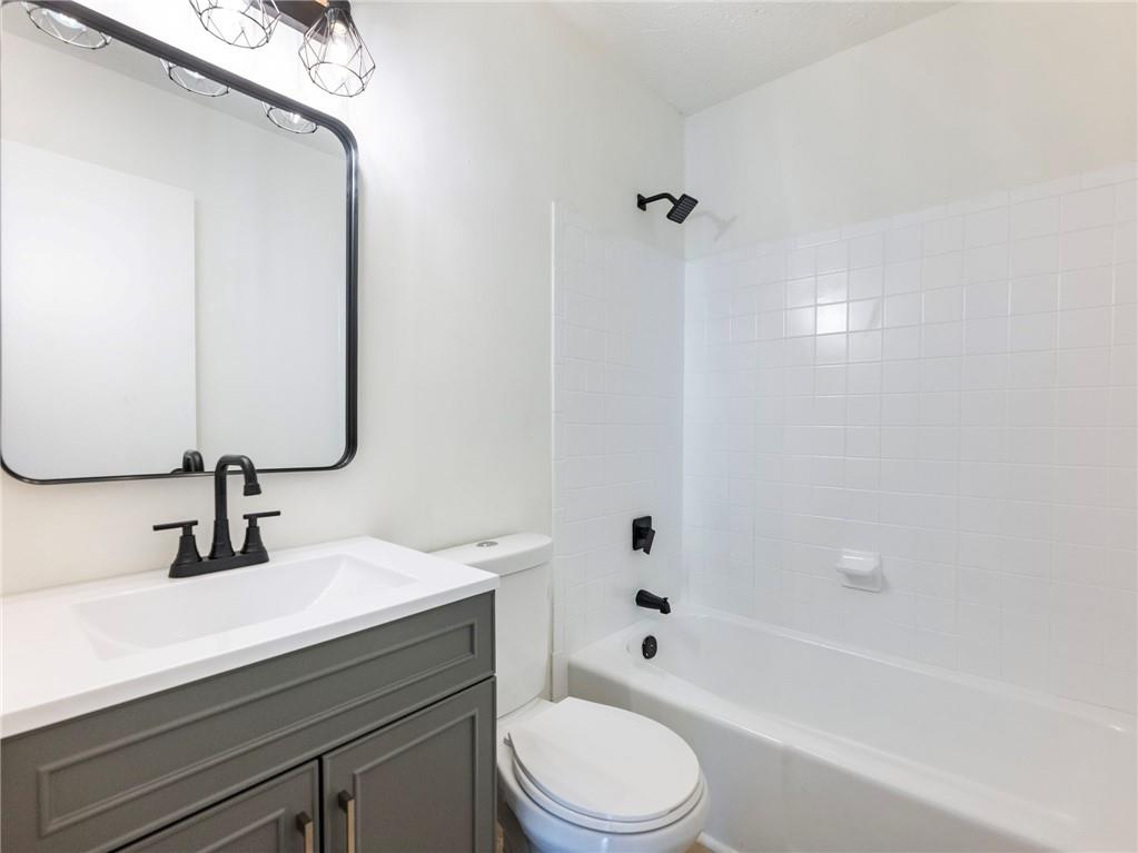 930 Woodbridge Drive Northeast Conyers, GA 30012 - Photo 19 of 38 a bathroom with a sink a toilet and shower
