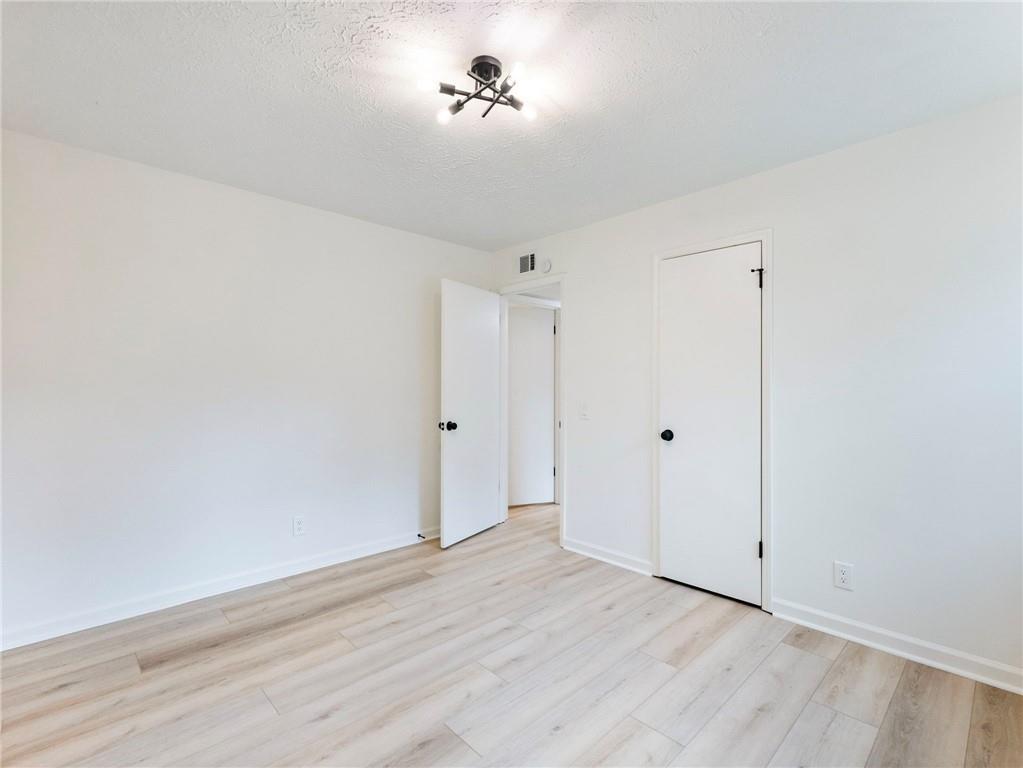 930 Woodbridge Drive Northeast Conyers, GA 30012 - Photo 23 of 38 a view of a room with wooden floor and a ceiling fan
