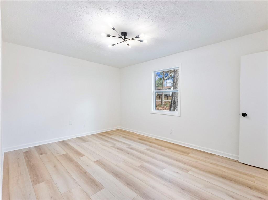 930 Woodbridge Drive Northeast Conyers, GA 30012 - Photo 24 of 38 wooden floor in an empty room with a window