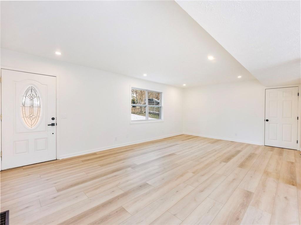 930 Woodbridge Drive Northeast Conyers, GA 30012 - Photo 9 of 38 an empty room with wooden floor and windows