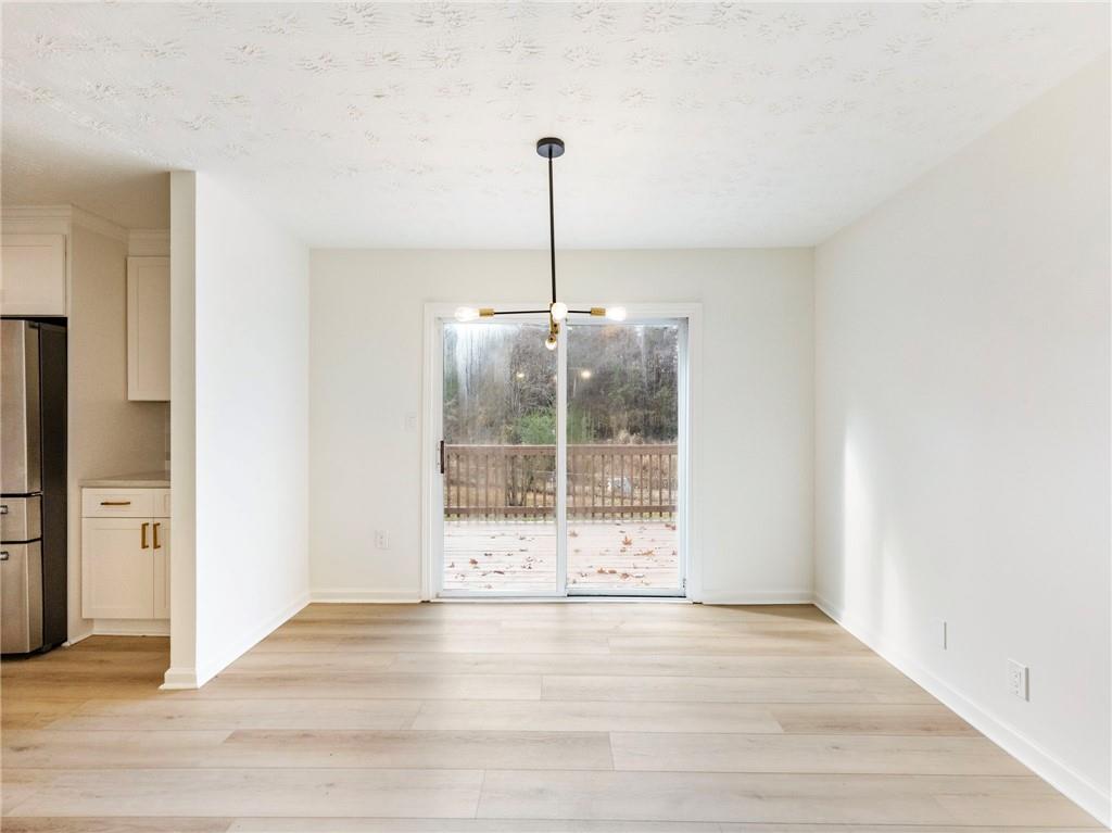 930 Woodbridge Drive Northeast Conyers, GA 30012 - Photo 10 of 38 a view of a room with wooden floor and a ceiling fan
