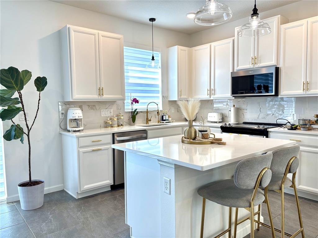 921 Spring Palms Loop Orlando, FL 32828 - Photo 15 of 43 a kitchen with a sink cabinets and window