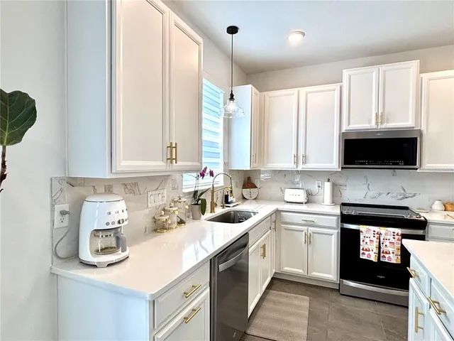 a kitchen with a sink a window and cabinets