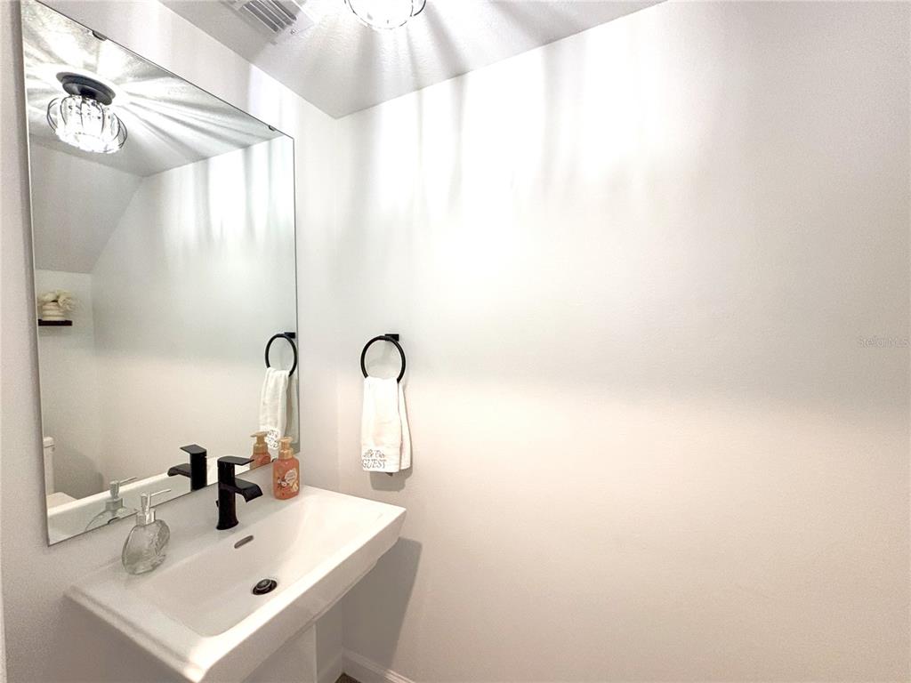 921 Spring Palms Loop Orlando, FL 32828 - Photo 20 of 43 a bathroom with a sink and a mirror