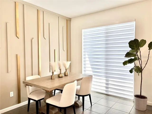 a view of a dining room with furniture and a potted plant