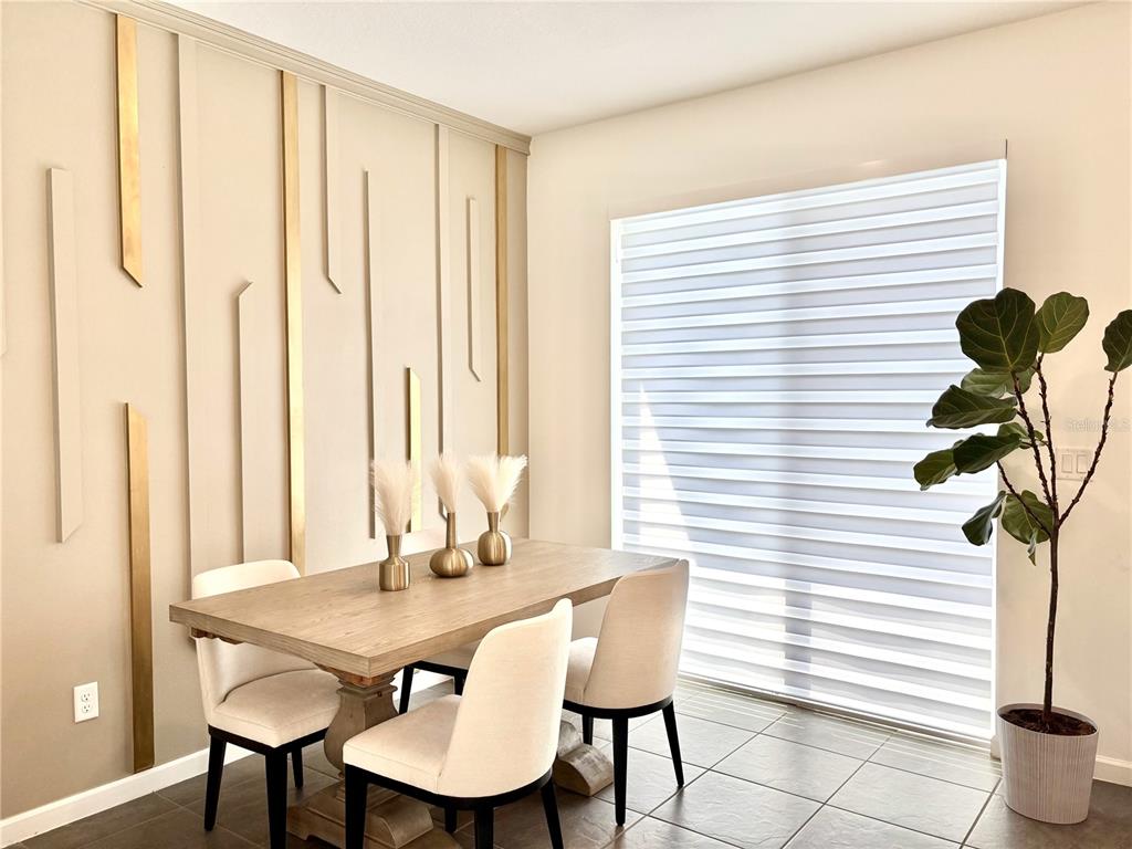 921 Spring Palms Loop Orlando, FL 32828 - Photo 21 of 43 a view of a dining room with furniture and a potted plant