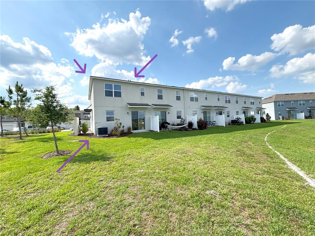 921 Spring Palms Loop Orlando, FL 32828 - Photo 34 of 43 a view of a house with a big yard and a large tree