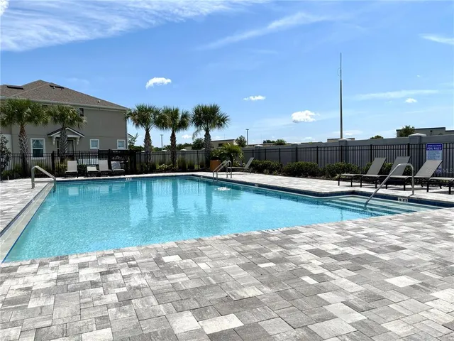 a view of a swimming pool with a patio