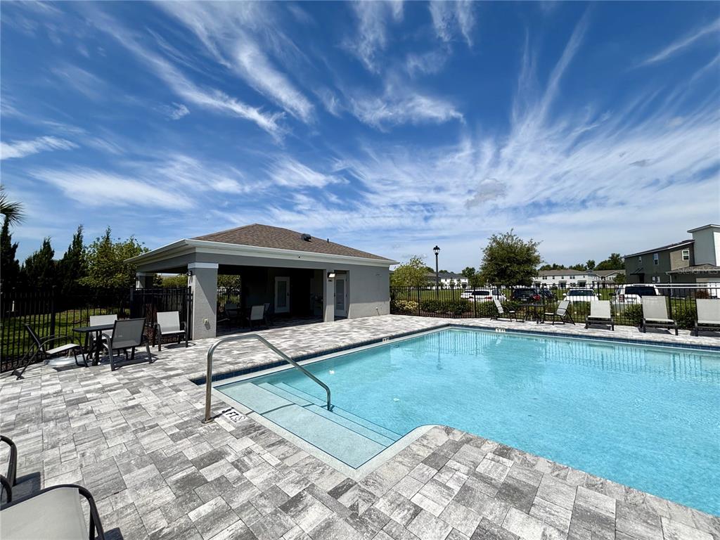 921 Spring Palms Loop Orlando, FL 32828 - Photo 42 of 43 a swimming pool with outdoor seating and yard