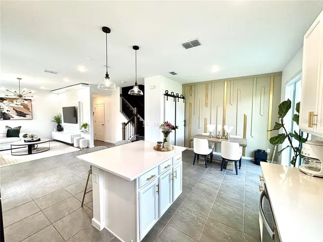 a large white kitchen with a large window