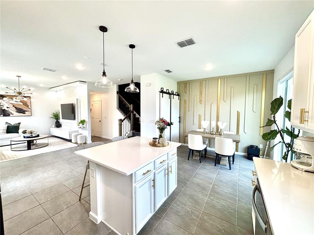 921 Spring Palms Loop Orlando, FL 32828 - Photo 6 of 43 a large white kitchen with a large window
