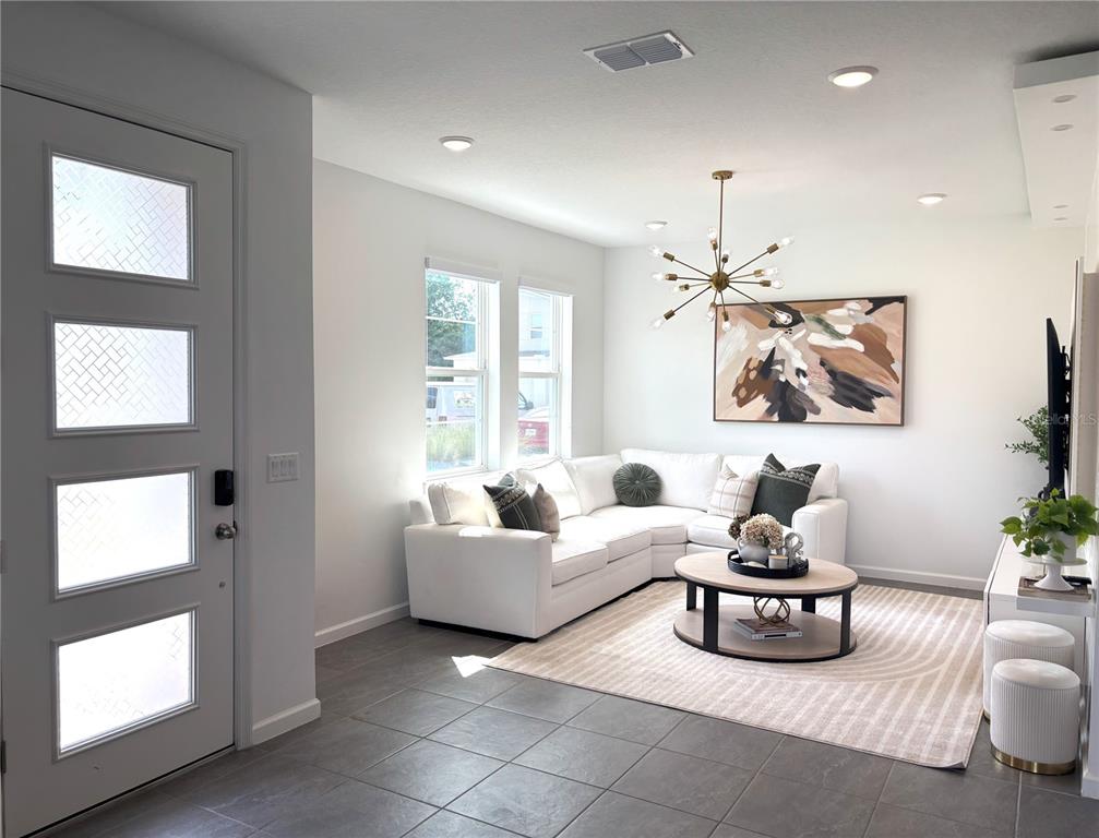 921 Spring Palms Loop Orlando, FL 32828 - Photo 7 of 43 a living room with furniture and a large window