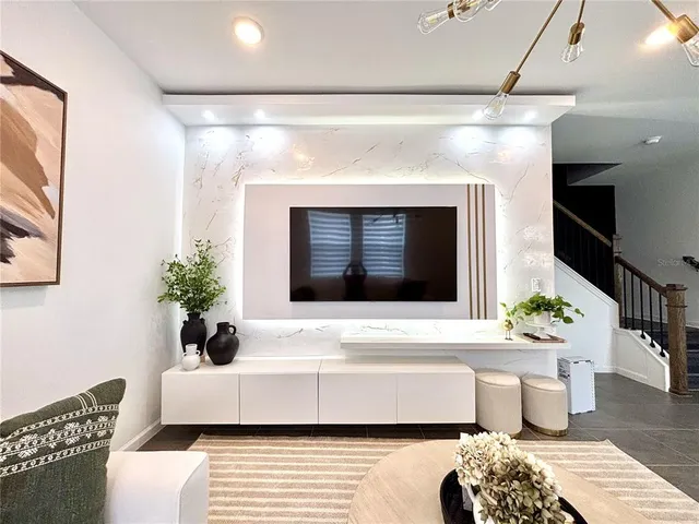 a living room with furniture and a flat screen tv