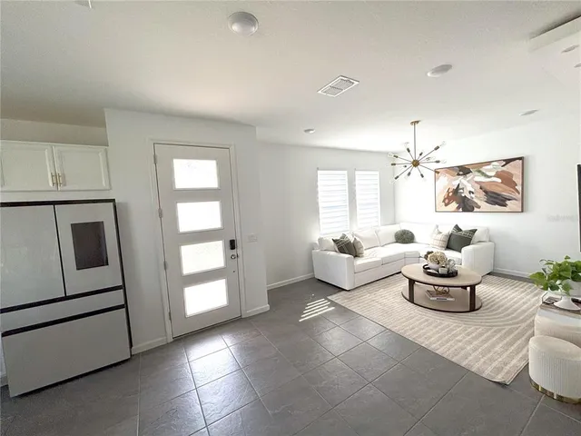 a living room with furniture and white walls