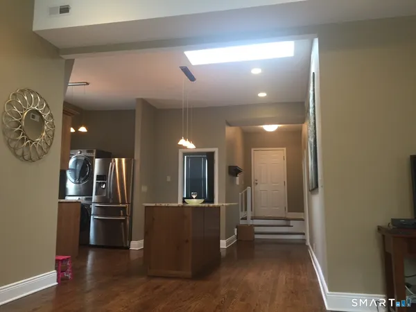 a view of a kitchen with a refrigerator and a stove