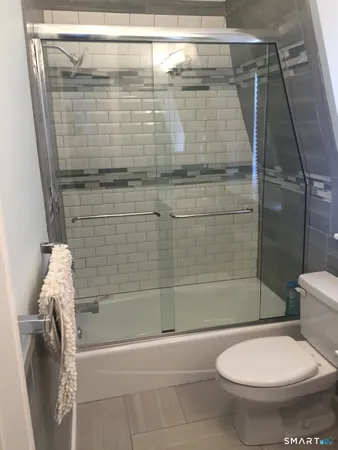 a bathroom with a shower and a toilet