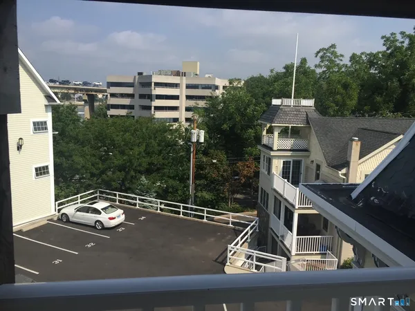 a view of a balcony with two chairs and a table