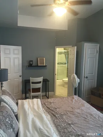 a bedroom with a bed and a dresser