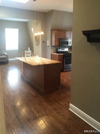a room with wooden floor and a sink