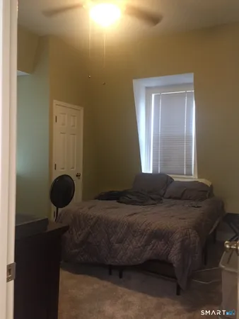 a bedroom with a bed and window